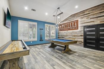 A room with a pool table and a sign that says "Monterra.".